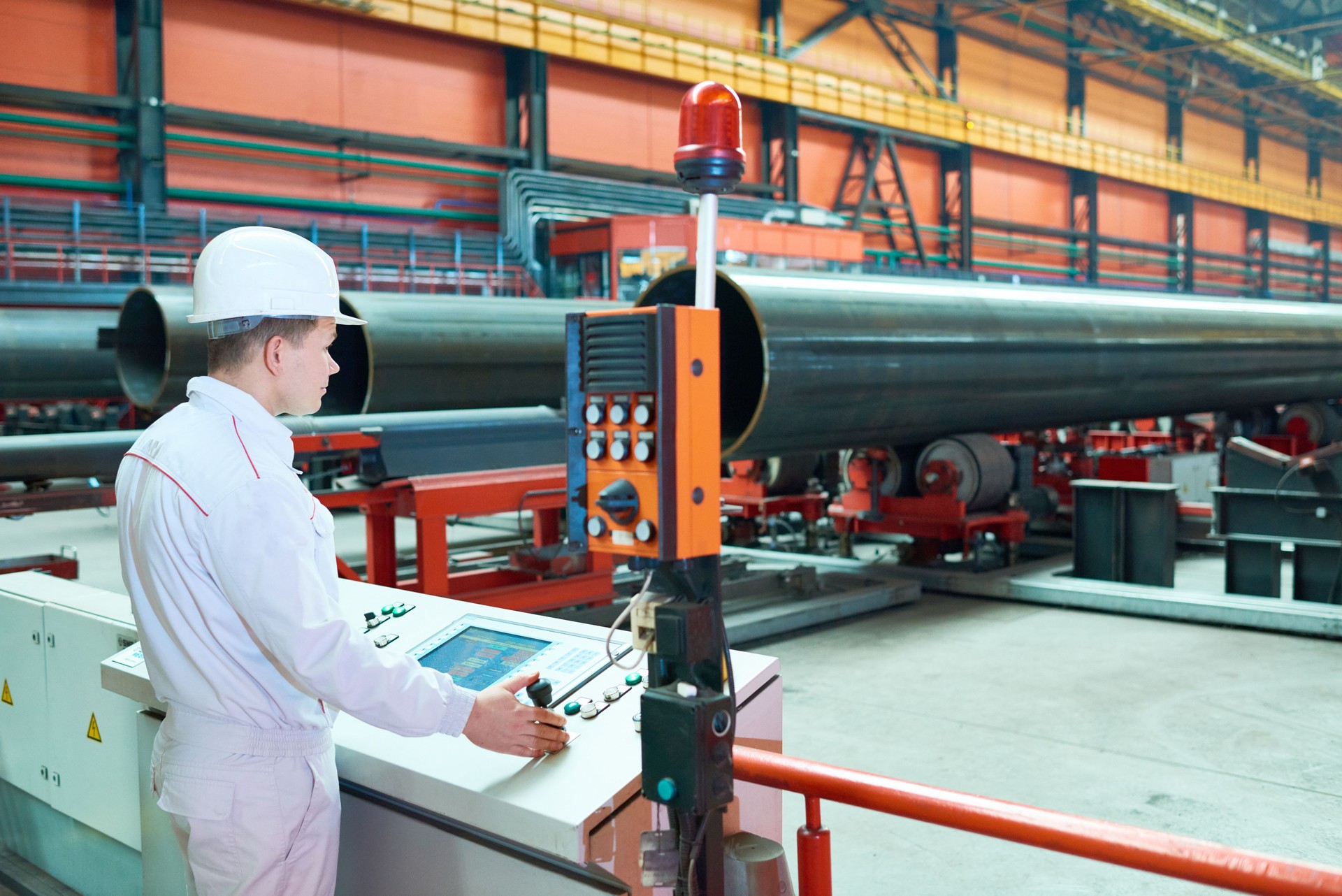 Qualified factory employee setting up machine
